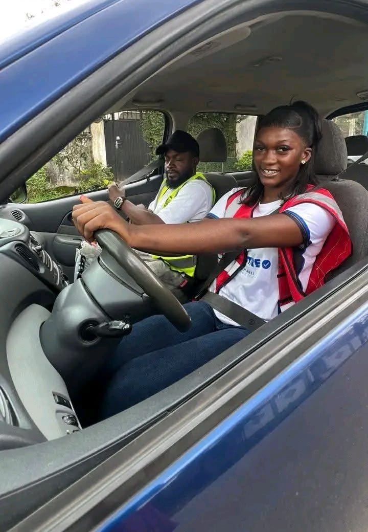 A Chia-Auto-Ecole student at the wheel with her instructor beside her, Douala